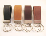 Choice of leather keychains in black, brown, and tan colors with metal key rings.