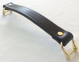 A black replacement handle for luggage or a briefcase featuring a black leather strap with gold-colored metal hardware.