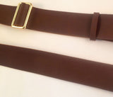 Brown leather strap with a gold buckle