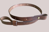 An antique brown leather rifle sling with  adjustment, designed for a carbine or rifle.