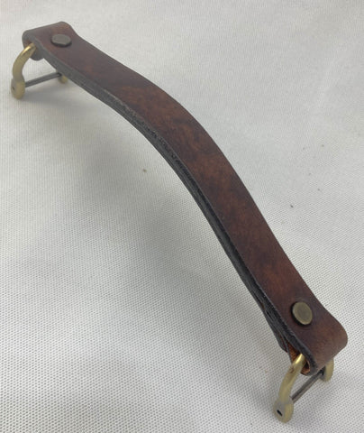 An antique dark brown leather replacement handle  for luggage or a briefcase.