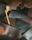  large scrap leather pieces in brown, black, and chocolate colors with suede backs and a satin finish.